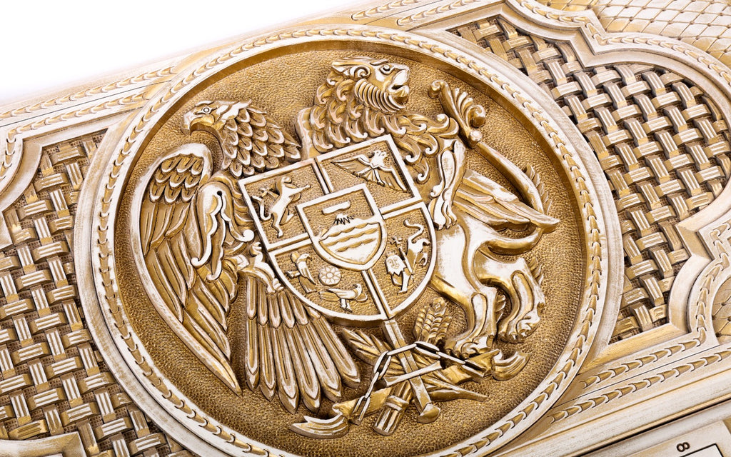 Close-up of the coat of arms: eagle and lion holding the shield with Ararat, carved in deep relief and aged with gold