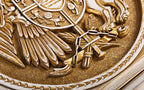 Sword, broken chain, wheat and feather carved beneath the shield of the Armenian coat of arms, close-up