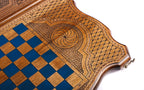 Blue epoxy chequerboard and eternity whirl cartouche on the back cover, angled view