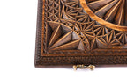 Close-up of the faceted pyramids and the ridged ring on the lid, cast-bronze clasp at the edge