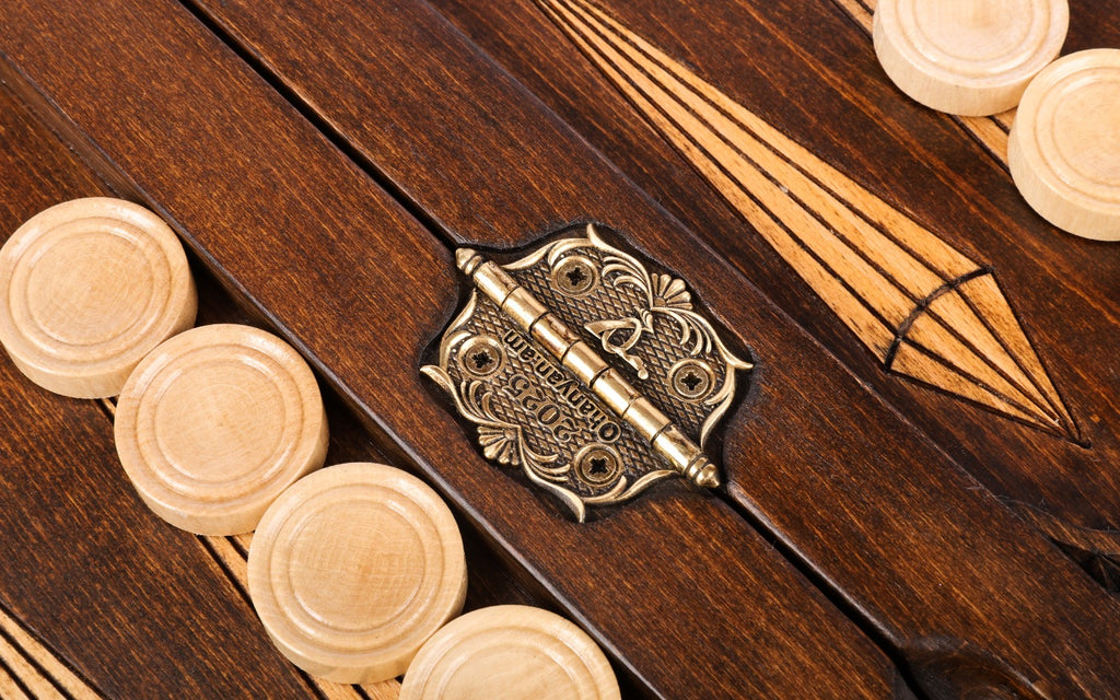 Stamped cast-bronze hinge on the centre bar with pale checkers and points either side