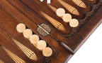Open backgammon board with checkers on the points and the stamped hinge, angled view