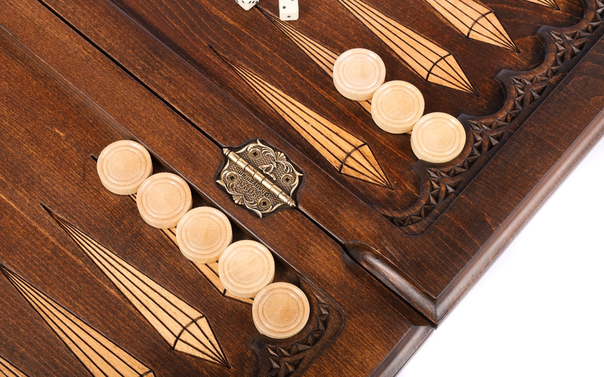 Open backgammon board with checkers on the points and the stamped hinge, angled view