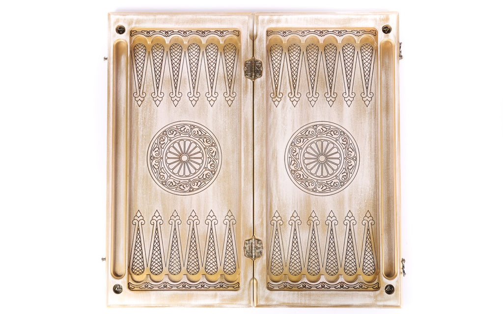 Open white and gold backgammon board 60 cm from above, pale points in line work and wheel ornaments
