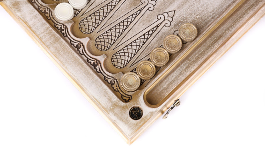 Corner of the open board with white checkers stacked on the points and the dice hollow