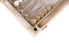 Corner of the open board with white checkers stacked on the points and the dice hollow