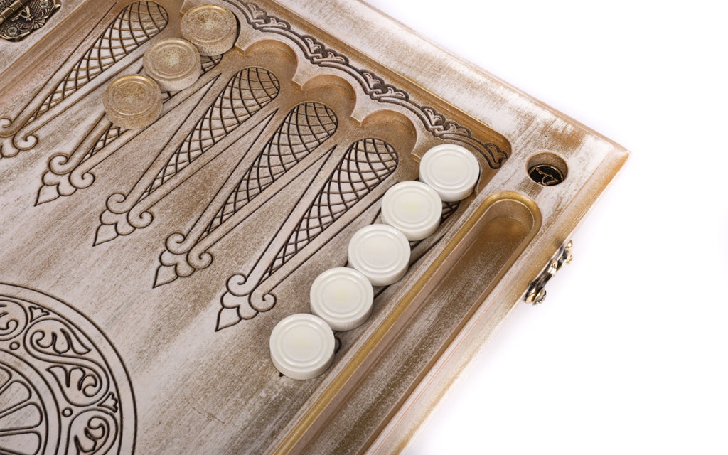 Points drawn in line with fleur-de-lys tips and white checkers on the open backgammon board