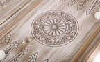 Petal wheel ornament with two dice on the open board, pale points around it