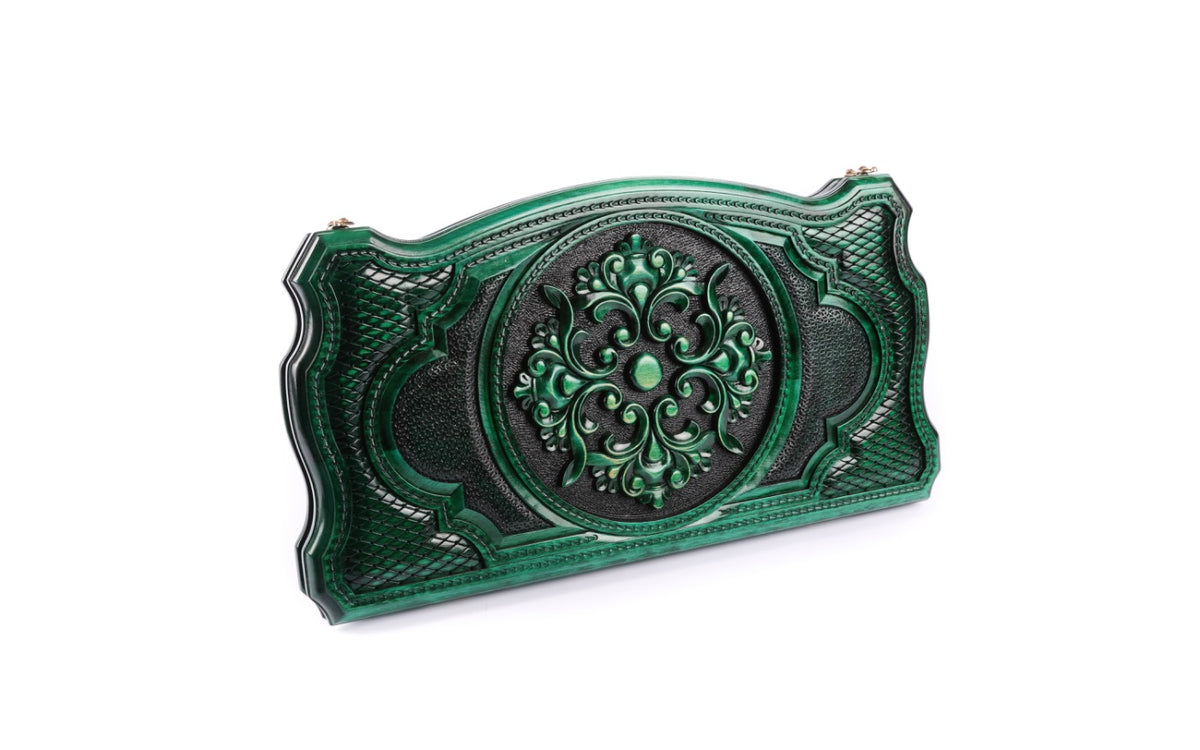 Green ornament backgammon set closed, front view of the round scroll ornament and lattice cartouche