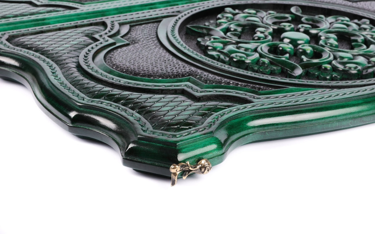 Close-up of the carved scroll ornament and lattice on the green contour lid, cast-bronze clasp at the edge
