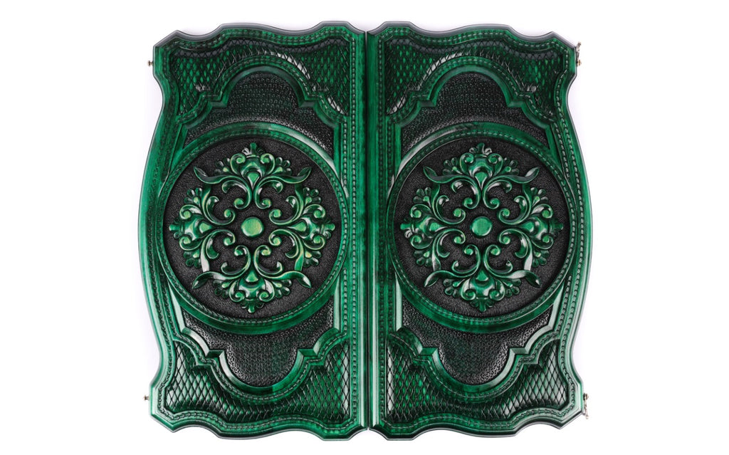 Both covers of the green backgammon set with the same scroll ornament in high relief, seen from above