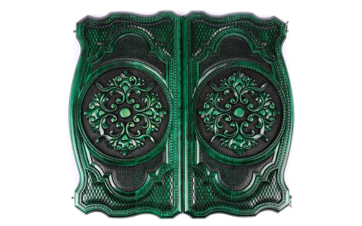 Both covers of the green backgammon set with the same scroll ornament in high relief, seen from above