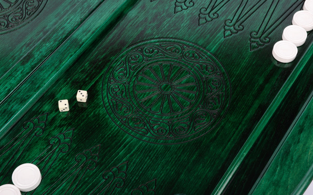Wheel ornament and two dice on the open green backgammon board