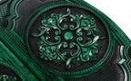 Scroll ornament carved in high relief, green on the ridges and black in the hollows, close-up
