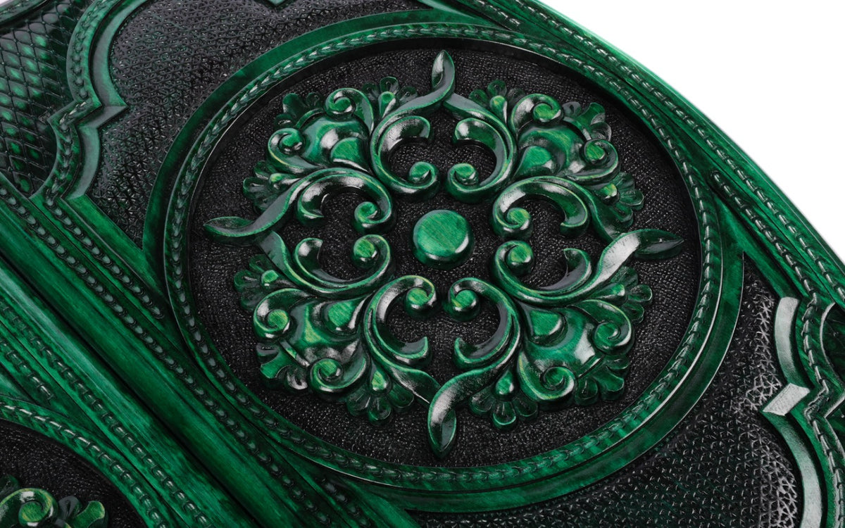 Scroll ornament carved in high relief, green on the ridges and black in the hollows, close-up