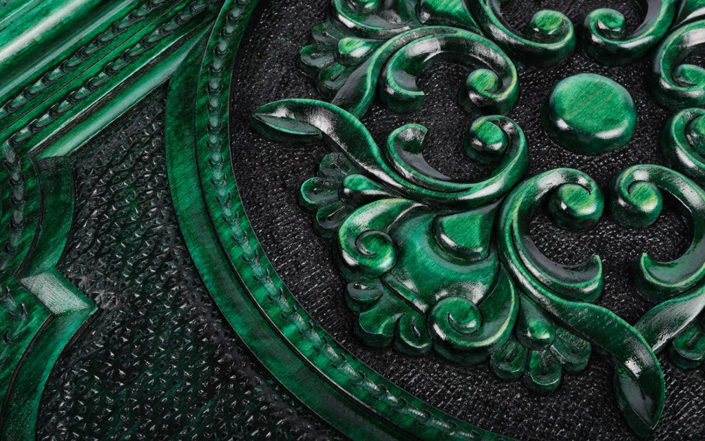 Domed centre and curling leaves of the carved ornament on the green backgammon set, close-up