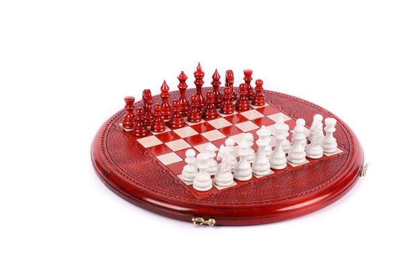 Round wooden chess set painted red and white with hand-carved border, pieces set for play