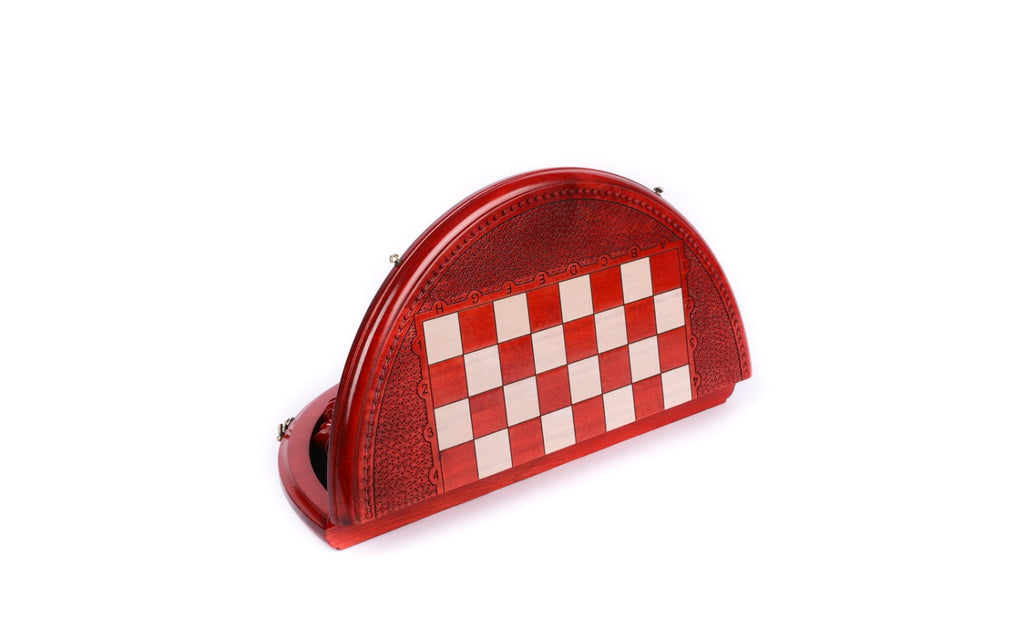 Red and white round chess board folded and standing on edge, carved rim visible