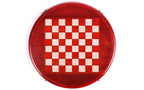 Top-down view of the round wooden chess board with red and cream squares and carved rim
