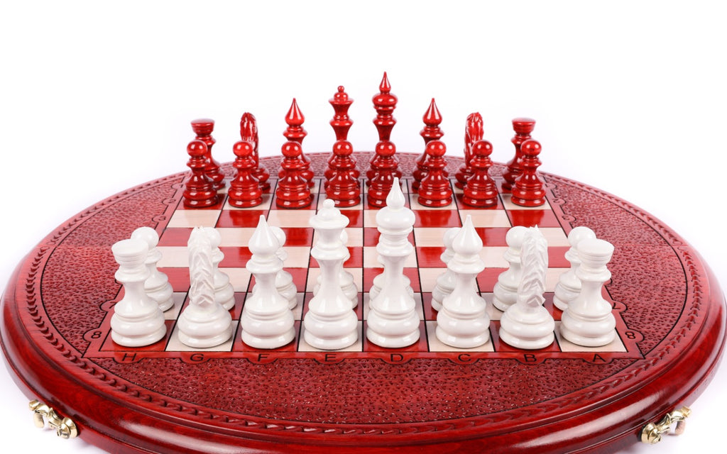 Front view of the round red and white chess set with pieces in position