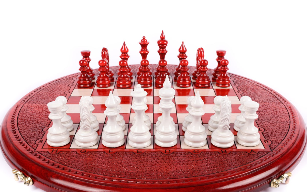 Front view of the round red and white chess set with pieces in position