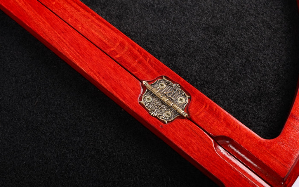 Cast-bronze hinge inside the velvet-lined compartment of the round chess board