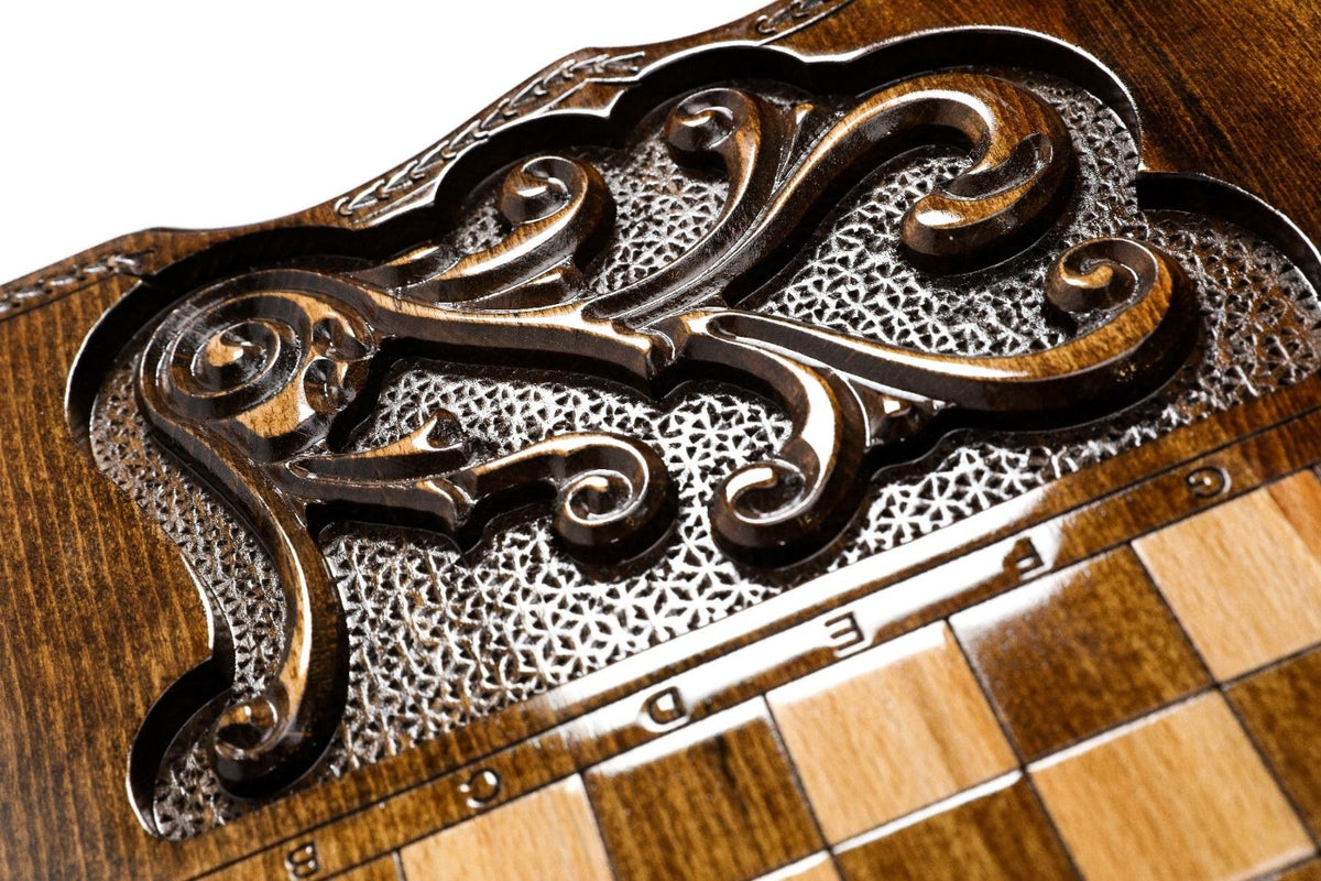 Carved scroll panel beside the chequerboard on the back cover, close-up