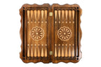 Open backgammon board 60 cm from above: dark field, pale points, wheel ornament on each half