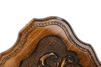 Corner of the contour lid with the bead moulding and the stippled ground around a scroll