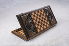 Back of the wooden backgammon set with an inlaid chequerboard between two carved spirals