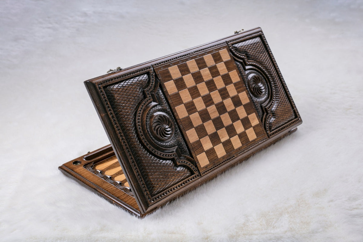 Back of the wooden backgammon set with an inlaid chequerboard between two carved spirals