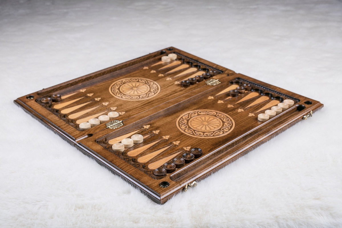 Backgammon set open with pale and dark checkers set up and a twelve-petal wheel on each half
