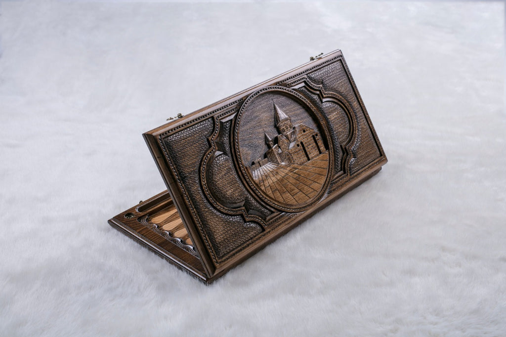 Backgammon set half open on the Geghard Monastery face, carved church with its conical dome and bell tower
