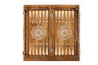 Top view of the open wooden backgammon board, carved points and a spoked wheel on each half, 60 cm