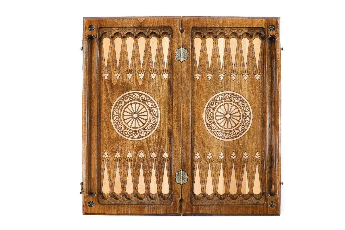 Top view of the open wooden backgammon board, carved points and a spoked wheel on each half, 60 cm