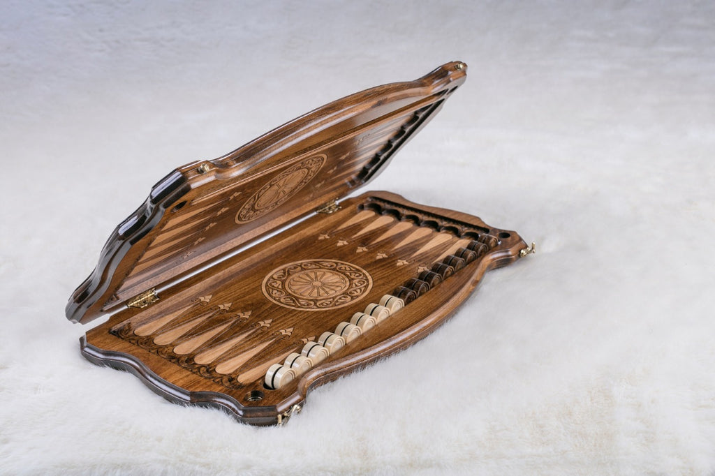 Armenian backgammon set opening, carved points, a wheel ornament and checkers in the side trays