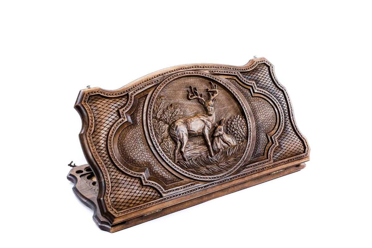 Stag and resting doe backgammon set half open, the deer carved in a round frame, contour outline, 60 cm