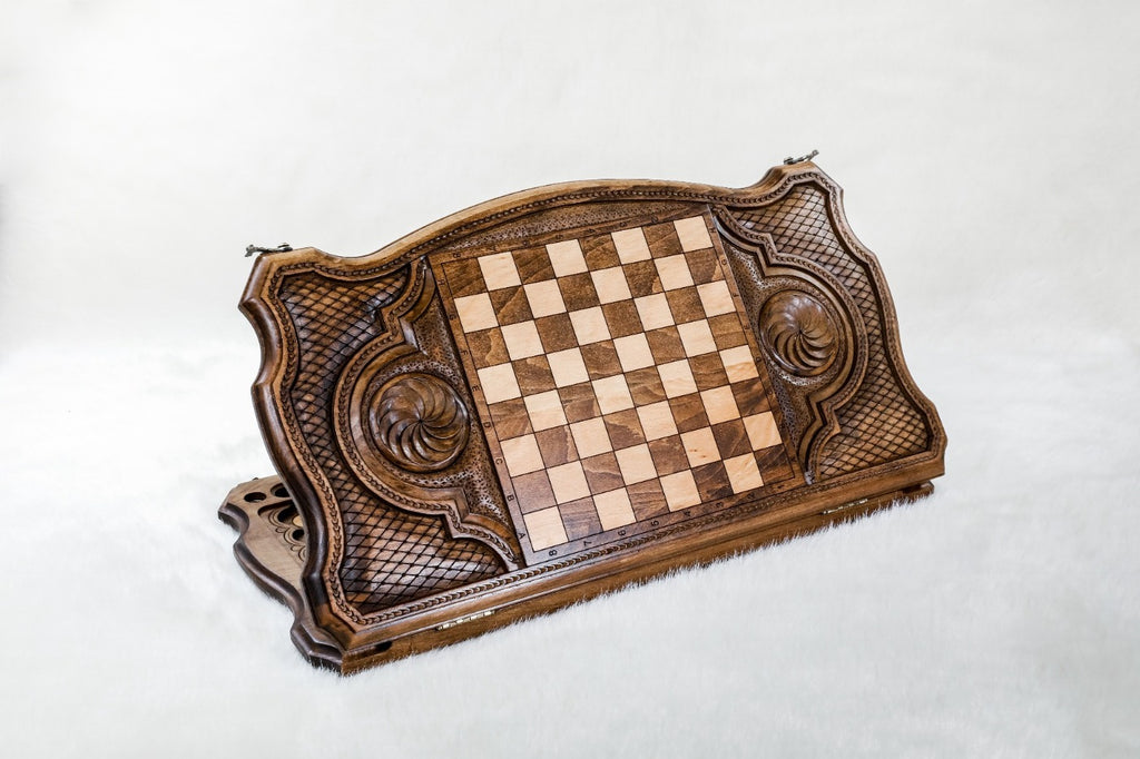 Back of the stag backgammon board, inlaid squares between two carved eternity whirls
