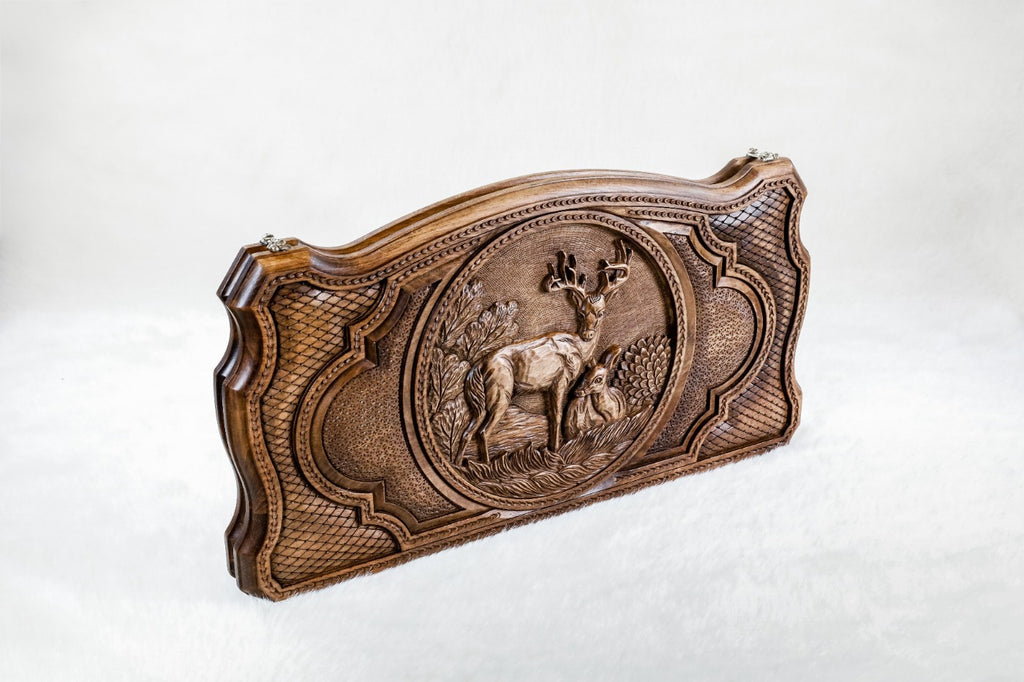 Backgammon board standing on edge, the round deer scene framed by scale lattice and lobed panels