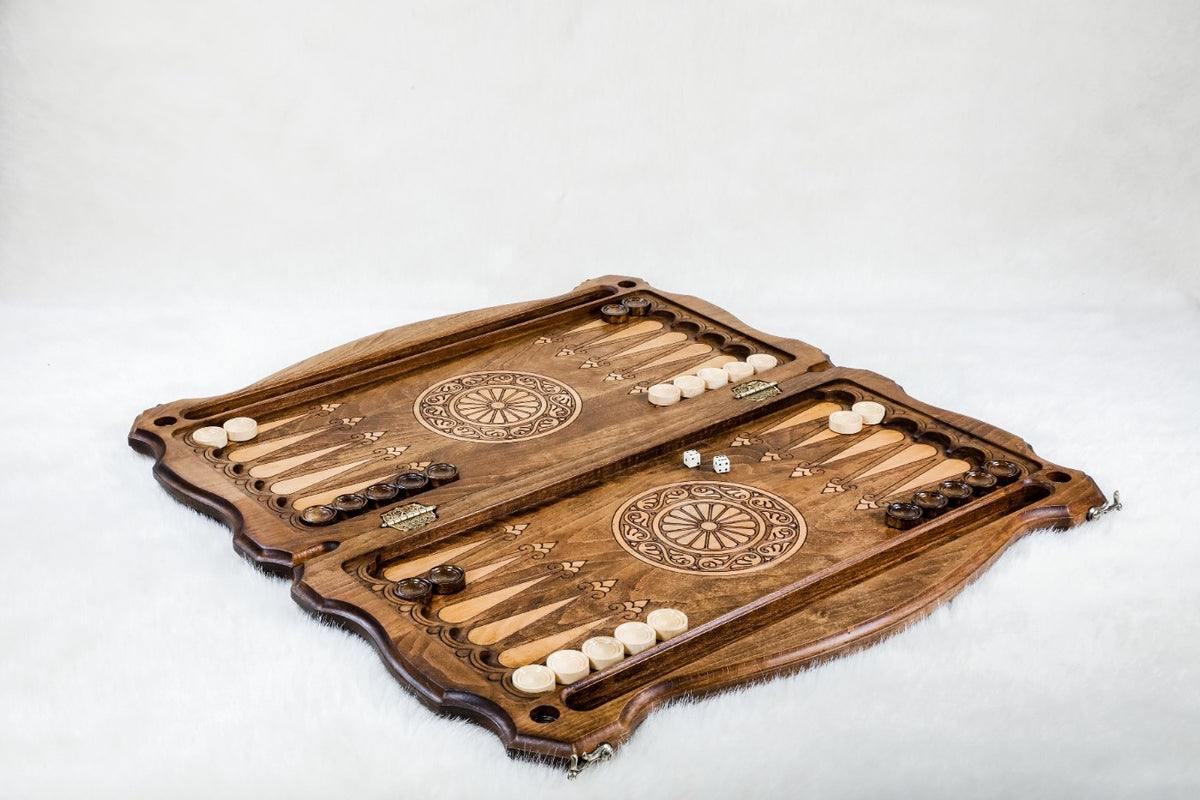 Wooden backgammon set laid open with light and dark checkers set up