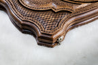 Close-up of the scale lattice, rope border and shaped contour edge beside a clasp