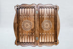 Top view of the open backgammon board, pale carved points and a wheel ornament on each half, 23.6 inch