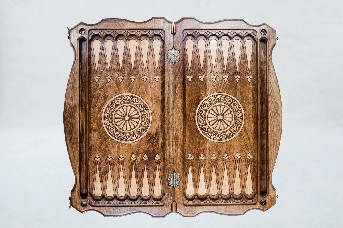 Top view of the open backgammon board, pale carved points and a wheel ornament on each half, 23.6 inch