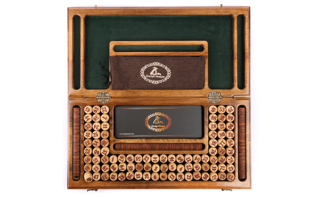 Open wooden lotto set from above with 90 numbered barrels and green felt