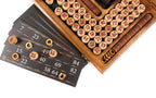 Lotto cards with wooden markers beside rows of numbered barrels