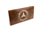 A close-up of the Mercedes emblem carving, showcasing the precision and depth of the solid wood craftsmanship.