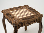 Carved legs of the wooden chess table